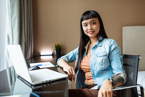 Female Asian entrepreneur working remotely from home