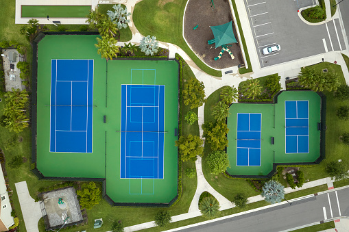 Aerial view of blue tennis courts for sports recreational activity.