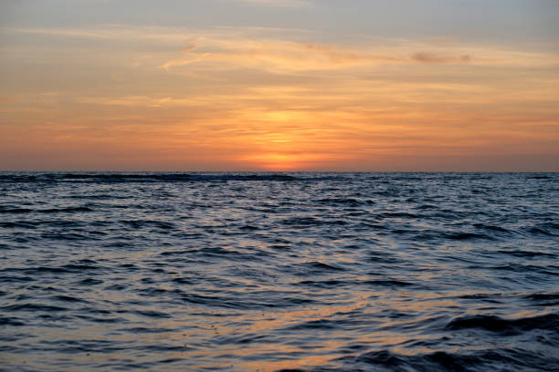 istock Dramatic red ocean waves at sunset with soft evening sea dark water 1482196843
