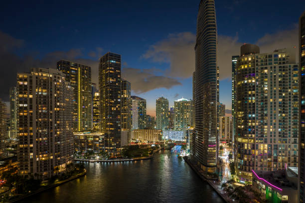 istock View from above of brightly illuminated high skyscraper buildings in downtown district of Miami Brickell in Florida, USA. American megapolis with business financial district at night 1482196958