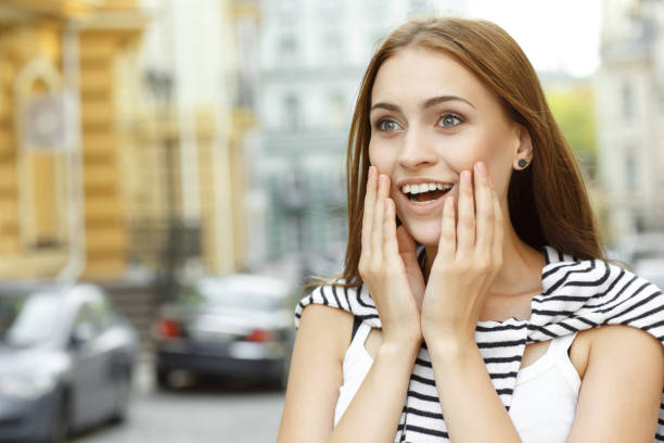istock Surprised girl with hands on face, looking ahead in city 1482198155