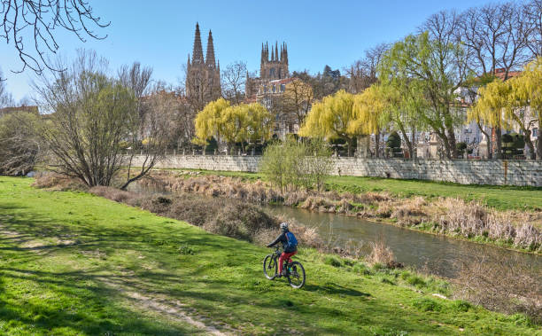 woman cycling with her electric bicycle in Burgos, Spain, Castile-Leon stock photo