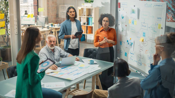 istock Modern Product Presentation Event: Successful Black Businesswoman Speaker Presents e-Commerce Startup Big Data Statistics, Charts, Revenue Growth Infographics for Startup Management Board 1482199209