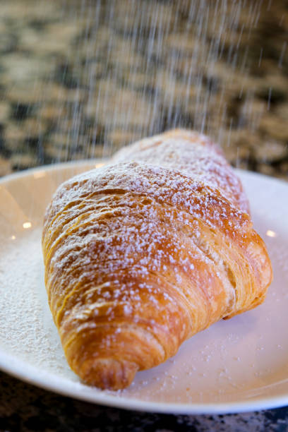 closeup delicious appetizing fresh crunchy croissants sprinkled with powdered sugar tasty food lunch snack porous structure baking diet place for text advertising menu french breakfast
