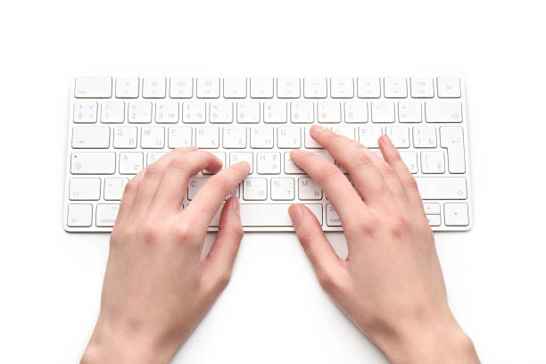 istock Woman Typing On A Keyboard White wireless computer keyboard isolated on white background. Russian / English keyboard layout. 1482207176