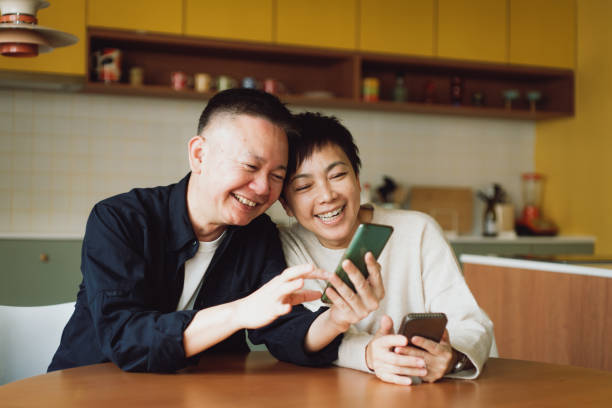 istock Asian couple using smartphone at home 1482207448