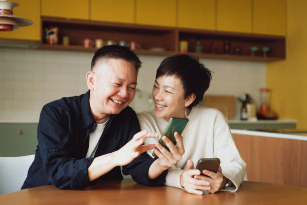 istock Asian couple using smartphone at home 1482207512