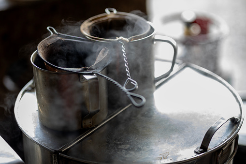 In a local coffee stall in Malaysia, a traditional method of making coffee or tea involves using equipment such as a filter cloth bag and pot on a water boiler.