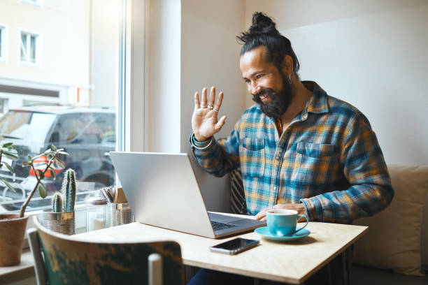 istock Cafe, wave or man on laptop video call planning SEO networking, conference or B2B sale. Small business or remote work employee on tech communication, social network strategy or research in restaurant 1482210913