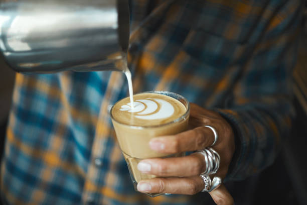 istock Latte art, coffee and barista hand with process, workflow and production with drink and working in cafe. Creative, man drawing with milk foam and hospitality with service and beverage closeup 1482210977