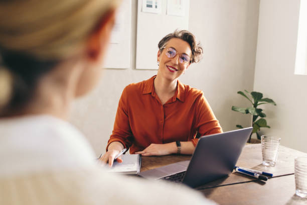 istock Happy hiring manager interviewing a job candidate in her office 1482213012