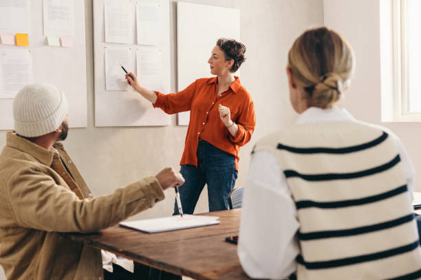 istock Mature businesswoman presenting some reports to her team 1482213064
