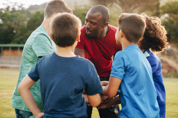 istock Male coach having a huddle with his school rugby team 1482213305