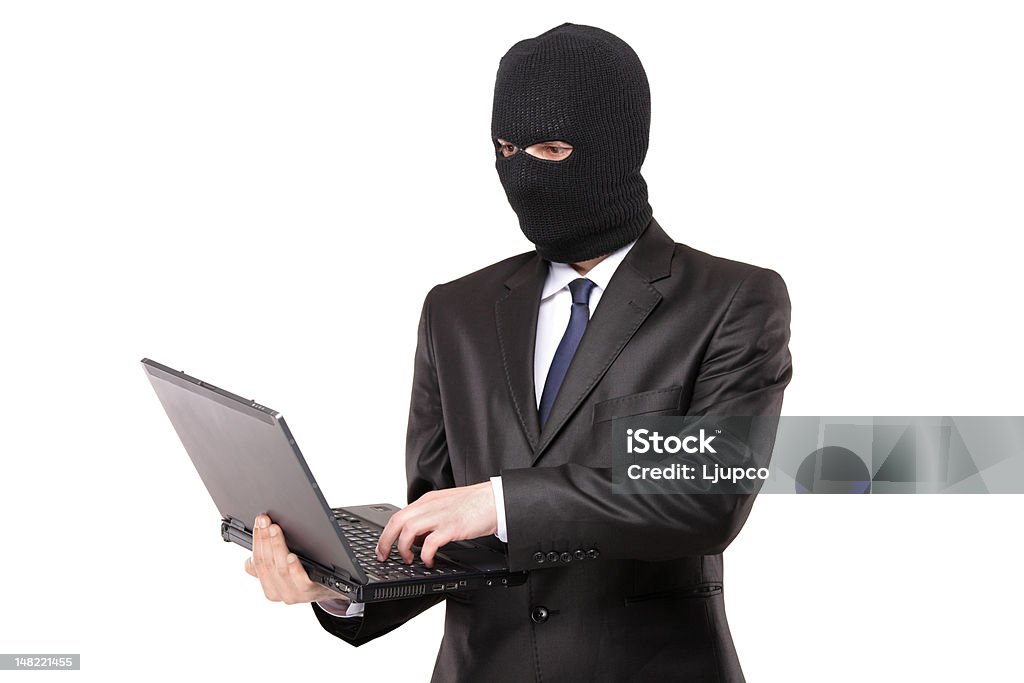 Hacker working on a laptop A hacker working on a laptop isolated on white background Computer Stock Photo