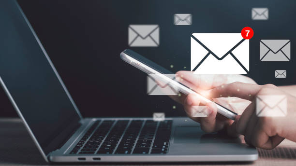 istock Email notification alert, E-mail marketing concept Businessman using laptop and smartphone with  mail message on virtual screen sending or reply online communication  social advertisement contact. 1482218520