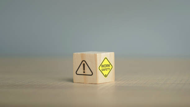 istock Work Safety text yellow and hand flip wooden cube and copy spec. Safety first sign on virtual screen. Hazards, protections, regulations and insurance, Zero accidents, Protection dangerous. 1482218816