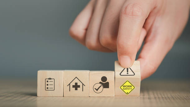 istock Work Safety text yellow and hand flip wooden cube and copy spec. Safety first sign on virtual screen. Hazards, protections, regulations and insurance, Zero accidents, Protection dangerous. 1482218822