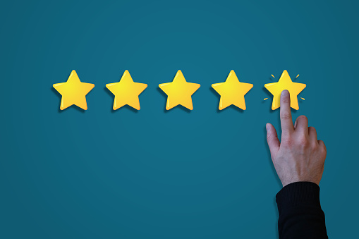 Online customer hand rating five stars on a blue gradient background