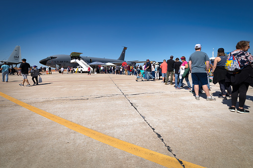 Tucson, Arizona, USA - March 25, 2023: A line of airshow fans waiting to tour an Air Force KC-135 Stratotanker at the 2023 Thunder and Lightning Over Arizona airshow.