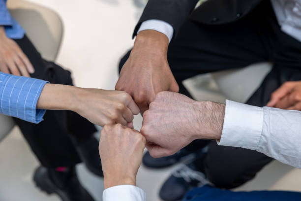 istock Close up of people holding hands during therapy session 1482220980