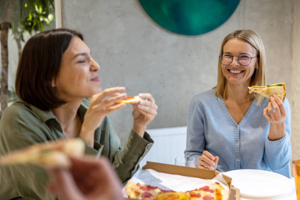 istock Friends having good time during lunch and enjoying pizza 1482221016