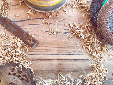 carpentry tools and wood shavings on a workbench