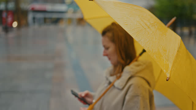 SLO MO Defocused - Typing on a smartphone on a rainy day