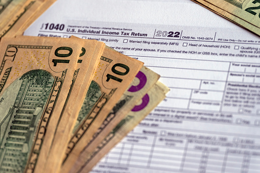 IRS form 1040 and dollars still life background.