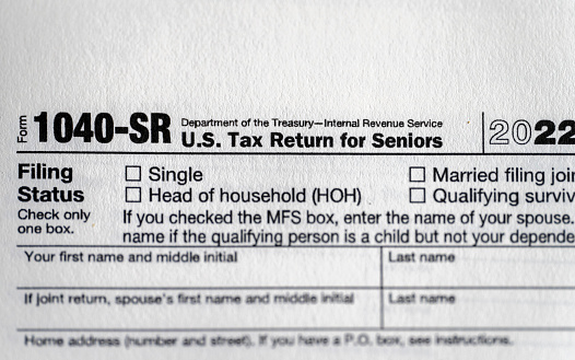 IRS form 1040-SR tax return form for seniors still life background.