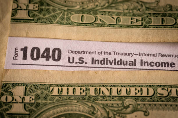 istock IRS form 1040 and dollars still life background 1482224839