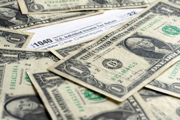 istock IRS form 1040 and dollars still life background 1482224873