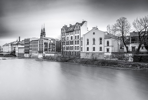A grayscale shot of an old town on the lakeside in Opole