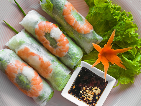 Traditional vietnamese spring rolls with shrimps, rice paper close up