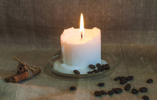istock White candle with coffee beans on the table 1482230684