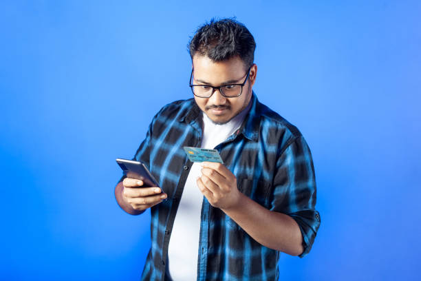 istock surprised college student using mobile phone with credit card 1482231162