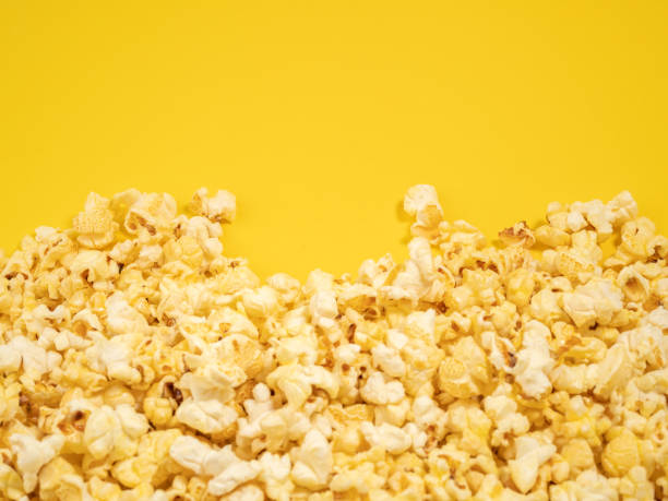 istock Popcorn on a yellow background. Sweet popcorn on yellow. 1482231209