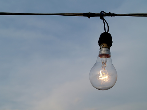 close-up hanging lamp illuminate the area outside the building with copy space