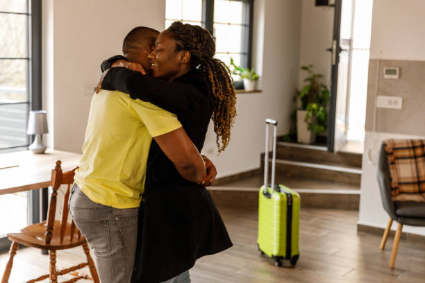 istock Cheerful young couple hugging after not seeing each other due to a work trip 1482233404