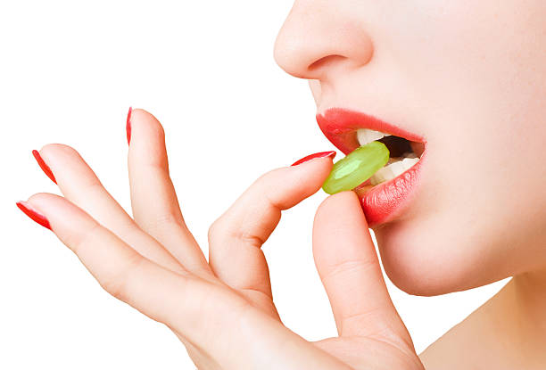 istock Woman fingers holding a candy 148223521
