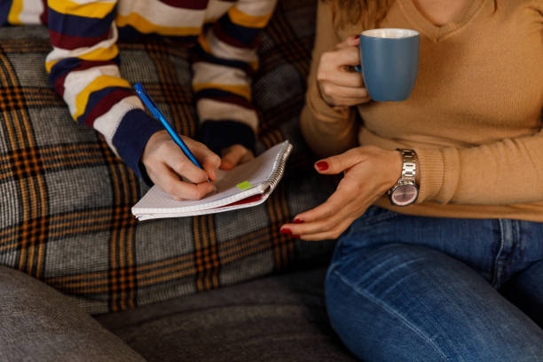 istock Woman having coffee and helping her son with a homework assignment 1482237176