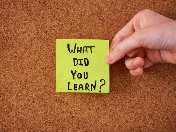 istock A young man holding a green sticky note with the question what did you learn written on it 1482238732