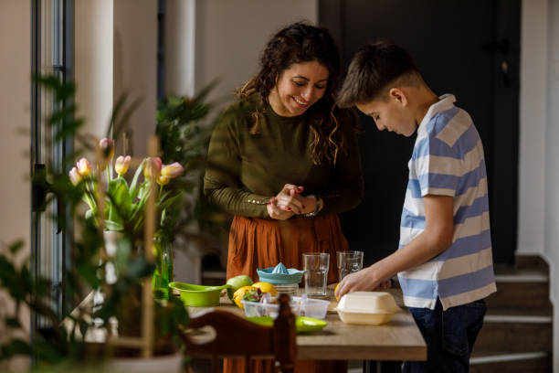istock Woman teaching her elementary age son how to make a refreshing lemonade 1482239499