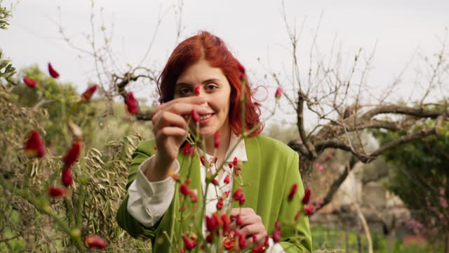 Girl from Calabria collects hot peppers from the plant in the farm