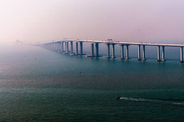 istock Boat sailing in the open sea with a bridge on the background 1482241789