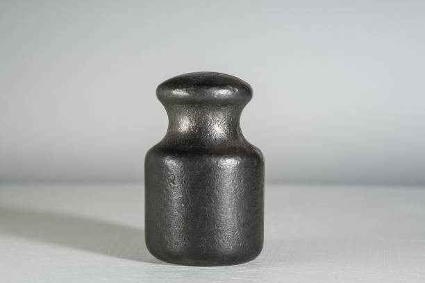 Old cast iron weight for weighing on a scale.