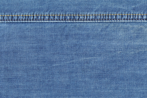 denim fabric with stitch. stiching setail. textured background closeup