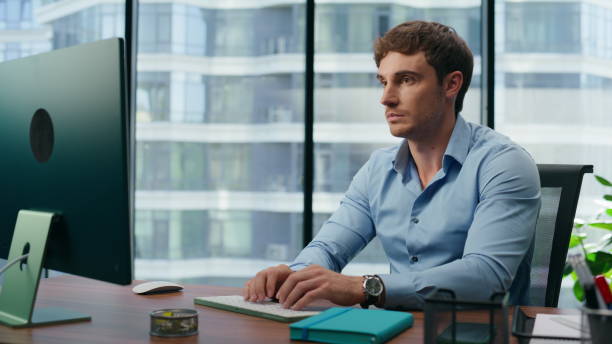 istock Focused businessman working computer in office. Serious employee typing keyboard 1482244005