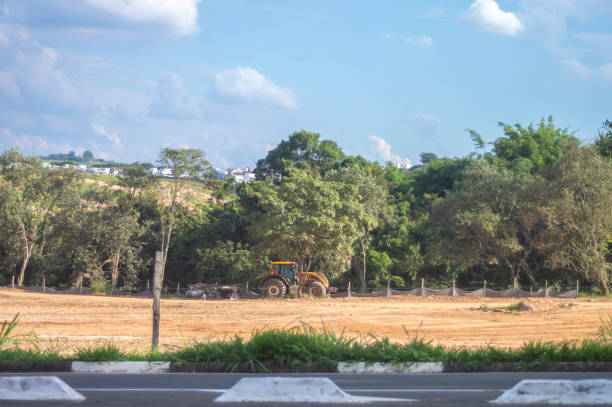 Campinas-sp,brasil-April 13,2023 Landscape showing trucks and tractors at the beginning of a construction that will become an urban area and cease to be a landscape of vegetation.