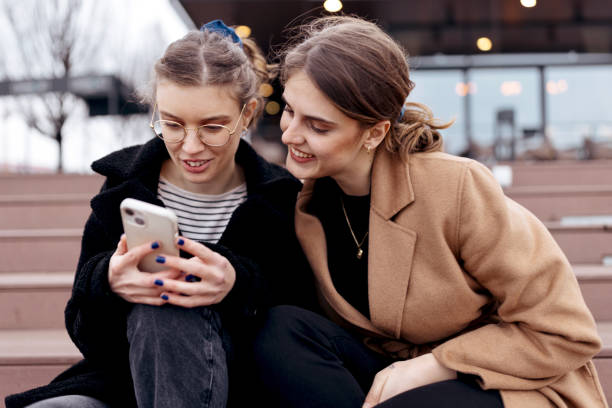 istock Beautiful girls using smartphones and having fun 1482247330