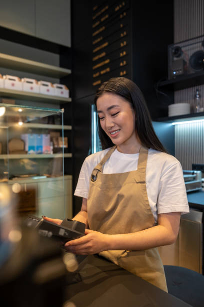 istock Joyous female cashier working in a cafe 1482248503